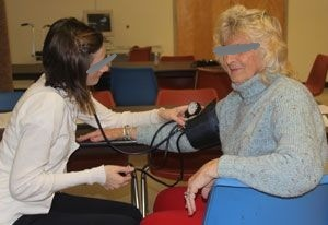 blood_pressure Employee having blood pressure measured through sweater at onsite biometric screening